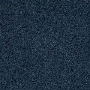 May include: A close-up of a dark blue textured fabric. The fabric has a slightly grainy appearance.