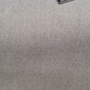 May include: Close-up of a light gray canvas fabric with a subtle woven texture.