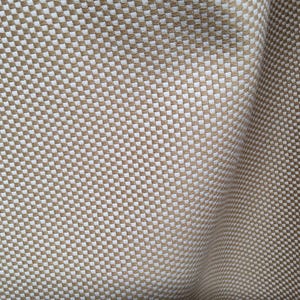 May include: A close-up of a beige fabric with a woven pattern of small white squares.