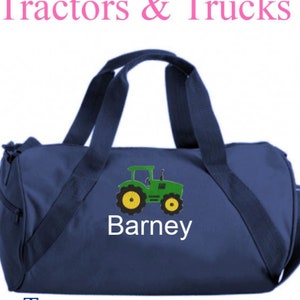 May include: A navy blue duffel bag with a green tractor and the name "Barney" embroidered on the front.
