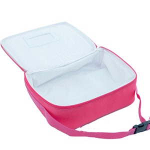 May include: A pink insulated lunch bag with a zipper closure and a shoulder strap. The bag has a white interior and a small clear window on the top.