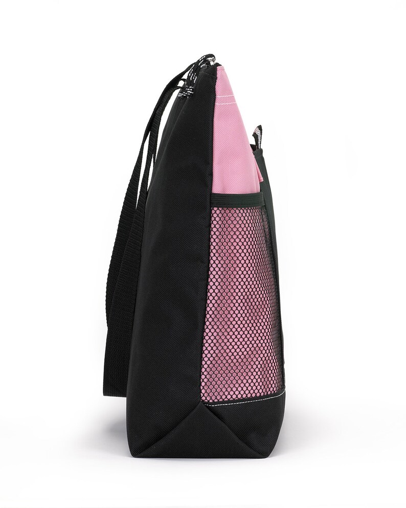 May include: A black and pink tote bag with a mesh pocket on the side. The bag has two long handles.