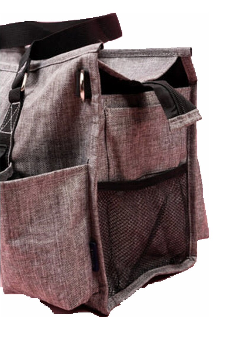 May include: A gray tote bag with multiple pockets and a black strap. The bag has a zippered top and a mesh side pocket. The material has a textured appearance. The bag is designed for carrying items.