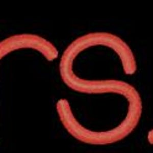 May include: Red embroidered text on a black background that reads "Mrs. B."