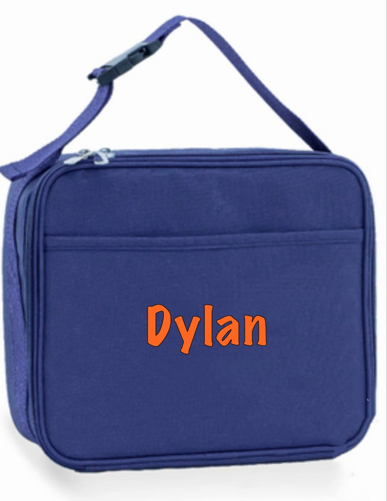 May include: A blue insulated lunch bag with a zipper closure and an adjustable shoulder strap. The bag has a front pocket and the name "Dylan" is embroidered on the front in orange.