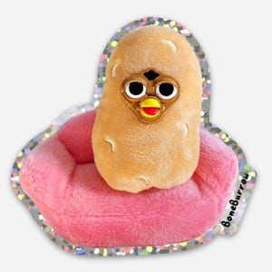 May include: A plush potato toy with googly eyes and a beak sitting on a pink plush sofa. The sofa has a sparkly border and the text "BoneBurrow" is printed on the side.