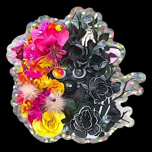 May include: A colourful floral arrangement featuring pink, yellow and orange flowers. The arrangement is accented with black roses and a black and white eye design.