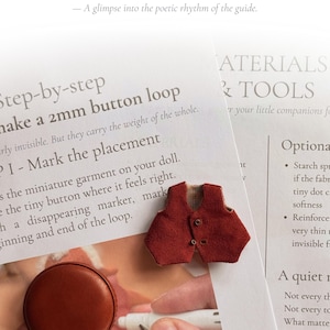 May include: A close-up of a sewing guide with a miniature red vest, a brown measuring tape, and small scissors. The text reads "Inside, you'll find quiet steps, warm hands, and old secrets of tiny sewing..." and "Step-by-step make a 2mm button loop."