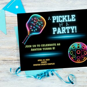 May include: A neon green and blue invitation for a pickleball party. The invitation features a neon green pickleball paddle and ball with the text "a PICKLE of a PARTY!" and "JOIN US TO CELEBRATE AS ASHTON TURNS 8!"  The invitation also includes the date and time of the party: "APRIL 23, 2025 2:00PM" and the location: "SPARTAN SPORTS COMPLEX".