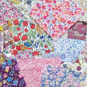 May include: A collection of colorful fabric squares with floral and geometric patterns. The fabrics are arranged in a patchwork design.