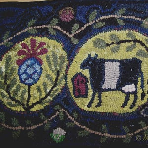 May include: Hand-hooked rug with a dark blue background and three yellow circles. The circles feature a thistle, a cow with a barn, and a stylized tree. The rug is a folk art style with a Wild Cranberry Hooked Rugs signature.