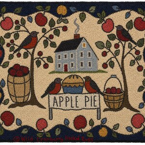 May include: A rectangular hooked rug featuring a central light blue house with a chimney, surrounded by two apple trees, a barrel of apples, a basket of apples, and three birds. A sign in the center reads APPLE PIE next to a pie on a table.