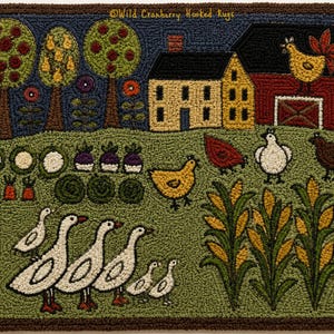 May include: A rectangular hooked rug featuring a farm scene with a yellow house, red barn, and a rooster on the roof. The landscape includes green fields, rows of vegetables, corn stalks, chickens, and a line of white geese. Text reads Wild Cranberry Hooked Rugs.