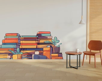 May include: A stack of colorful books against a white wall with a small potted plant and a brown wooden chair with a round table in front of it.