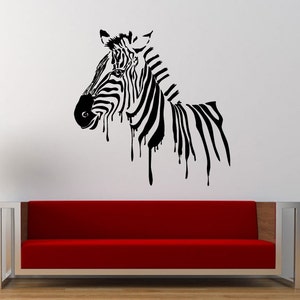 May include: Black and white zebra silhouette wall decal with a dripping effect. The zebra is facing left and has a striped pattern. The decal is on a white wall.