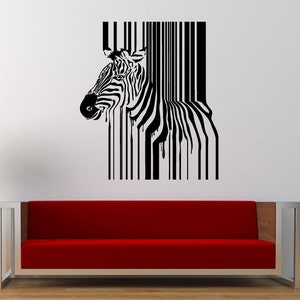 May include: Black and white wall art featuring a zebra head merging into a barcode design. The zebra's head is detailed with stripes, while the barcode effect creates a unique visual texture. The artwork is displayed on a white wall above a red sofa.