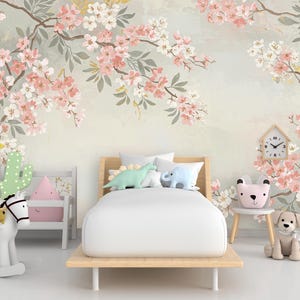 May include: A bedroom scene with a floral wallpaper featuring pink and white blossoms on branches. A wooden bed with white bedding is in the center. Decorative items include a clock, stuffed animals, and a rocking horse.