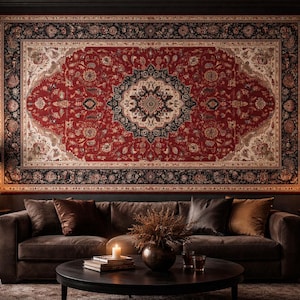 May include: A large, ornate red and black rug with a central medallion design hangs above a brown sofa. The rug features intricate floral patterns and a detailed border. The room is dimly lit, with side tables, lamps, and candles adding to the ambiance.