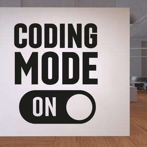 May include: A white wall with the words "CODING MODE ON" in bold black letters. The "ON" is represented by a black switch with a white circle. The image is in an office setting with a wooden floor.