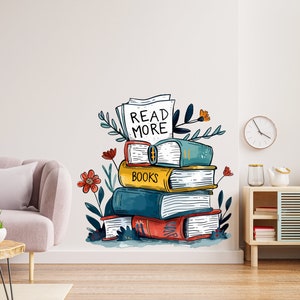 May include: A stack of colorful books with the words "Read More" and "Books" on the covers. The books are surrounded by green leaves and red flowers. The image is a wall decal.
