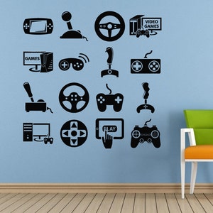 May include: A blue wall with black silhouette decals of video game controllers, joysticks, steering wheels, and game consoles. The text "VIDEO GAMES" is on one of the decals.