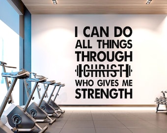May include: A white wall with a black motivational quote that reads "I can do all things through Christ who gives me strength". The quote is in a gym setting with stationary bikes in the foreground.