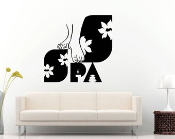 May include: Black and white silhouette of feet with flowers and the word "SPA" on a white background.