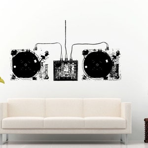 May include: Black and white illustration of two turntables connected by wires to a mixer. The illustration is on a white wall above a white couch.