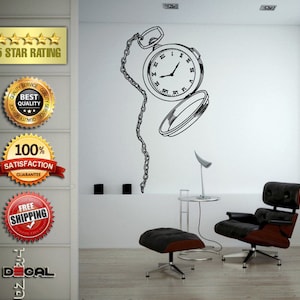 May include: Black and white wall decal of a pocket watch with a chain. The watch is open and the face is visible. The decal is on a white wall with a black leather armchair and ottoman in the foreground.