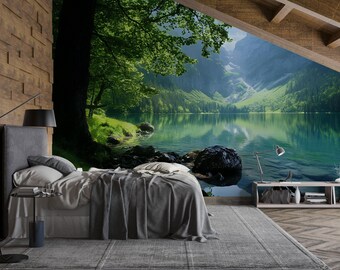 May include: A bedroom featuring a mural of a lake and mountains. The bed has grey bedding and pillows. A wooden accent wall and a grey rug complete the room's decor. A black lamp and side table are also visible.
