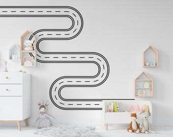 May include: Black and white road sticker design on a white wall. The sticker is shaped like a winding road with dashed lines. The sticker is above a white dresser and a white bench with a toy on it.