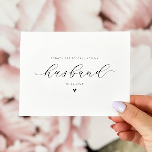 Personalized wedding card reading “Today I Get to Call You My Husband” with wedding date, modern minimalist personalized wedding day card held by hand.