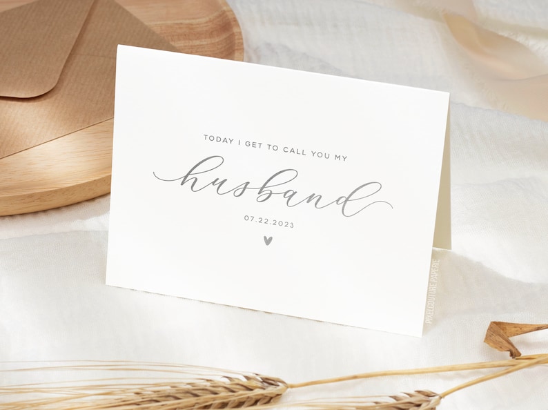 Personalized wedding day card reading “Today I Get to Call You My Husband” in silver foil with custom wedding date, modern minimalist bride to groom wedding card styled on neutral linen fabric.