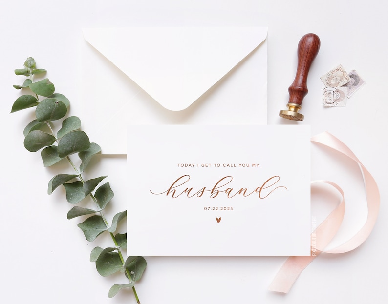 Personalized wedding day card reading “Today I Get to Call You My Husband” in rose gold foil with custom wedding date, modern minimalist bride to groom wedding card styled flat lay with envelope, ribbon, and eucalyptus.