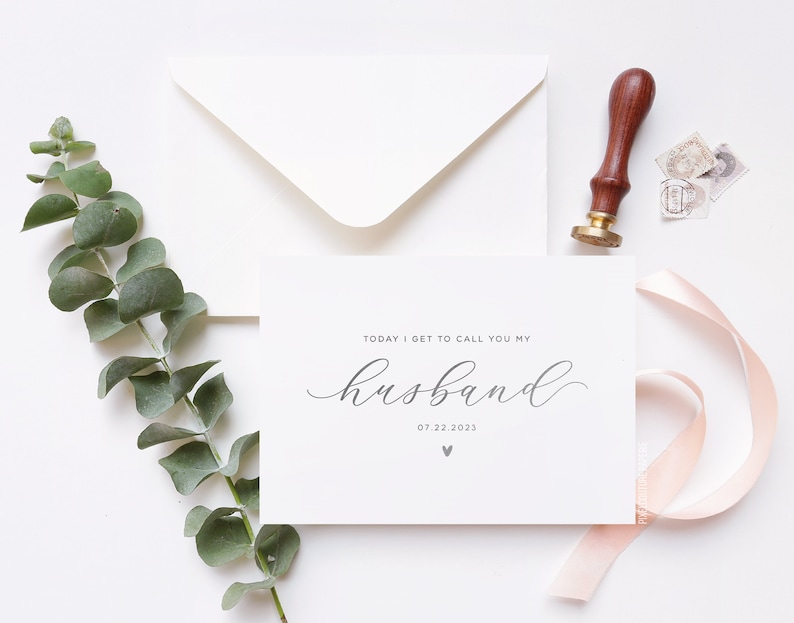 Personalized wedding day card reading “Today I Get to Call You My Husband” in silver foil with custom wedding date, modern minimalist bride to groom wedding card styled flat lay with envelope, ribbon, and eucalyptus.