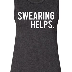 May include: Dark gray muscle tank top with the white text "SWEARING HELPS." The sleeveless shirt has a scoop neck and a slightly flared bottom. The Bella brand tag is visible at the neckline.