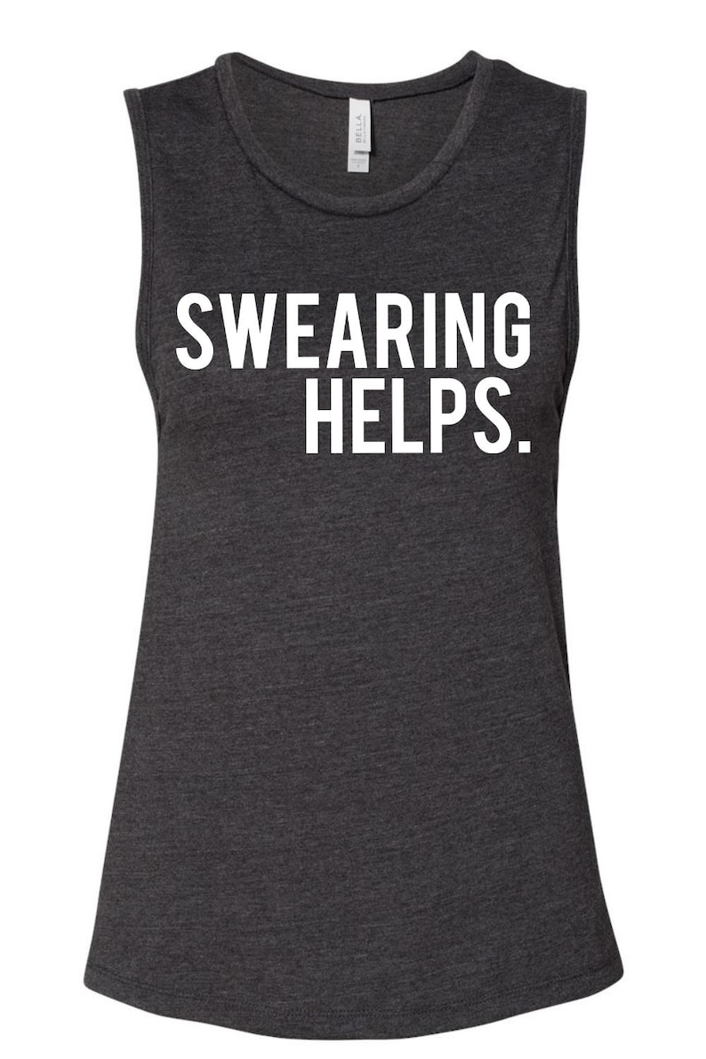 May include: Dark gray muscle tank top with the white text "SWEARING HELPS." The sleeveless shirt has a scoop neck and a slightly flared bottom. The Bella brand tag is visible at the neckline.