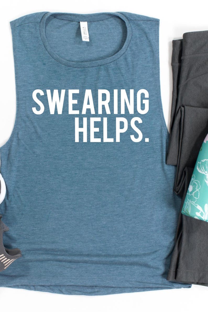 May include: A blue-green tank top with the text "SWEARING HELPS." in white block letters. The sleeveless shirt is paired with dark gray leggings and a teal and white patterned item.