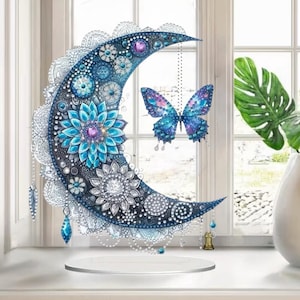 May include: A set of three ceramic mugs with a speckled, cream-colored glaze. Each mug features a different hand-painted design: a blue and green leaf, a yellow flower, and a red berry. The mugs have a simple, rounded shape.