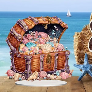 May include: A detailed illustration of an open treasure chest overflowing with colorful seashells and pearls. The chest is brown with decorative metal accents. A blue starfish and a woven bag are also visible, with a sailboat in the background.