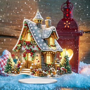 May include: A decorative Christmas house with a snowy roof, adorned with lights and festive greenery. A red lantern is to the right, and the house sits on a white platform, creating a charming holiday scene.