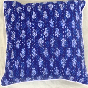 May include: A blue and white patterned throw pillow with a white border. The pillow is made of cotton and has a traditional Indian design.