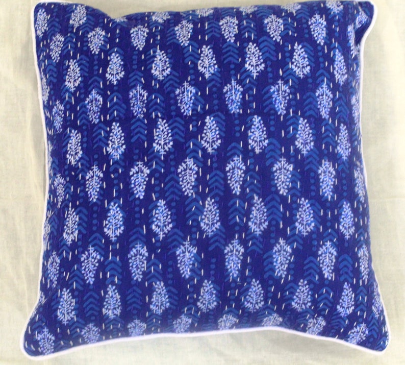 May include: A blue and white patterned throw pillow with a white border. The pillow is made of cotton and has a traditional Indian design.