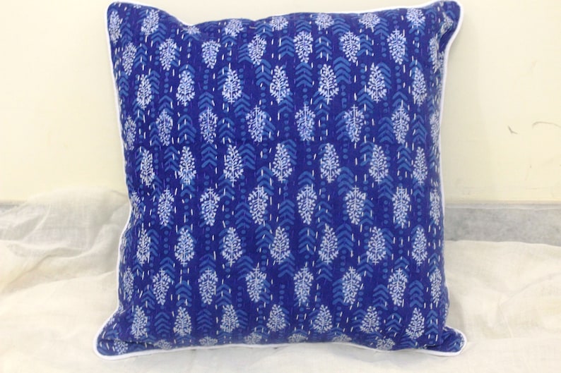 May include: Blue and white patterned cotton cushion cover with a white border. The pattern features a repeating design of small white leaves on a blue background.