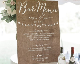 Könnte beinhalten: Ein Holzschild mit einer handgeschriebenen Bar-Karte für einen Hochzeitsempfang. Die Karte listet Spirituosen, Wein und Biersorten auf. Das Schild lautet "Bar Menu Keegan & Jou July 8, 2017".
