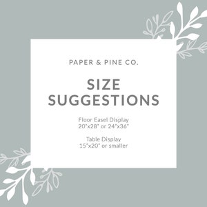 Peut inclure: Un rectangle blanc avec du texte gris sur un fond gris clair. Le texte indique "PAPER & PINE CO. SIZE SUGGESTIONS Floor Easel Display 20"x28" or 24"x36" Table Display 15"x20" or smaller". Le rectangle est entour&eacute; de motifs floraux blancs.