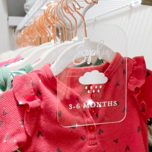 May include: A clear acrylic hanger tag with the name "Sophia" written in cursive, a cloud with raindrops, and the text "3-6 MONTHS".