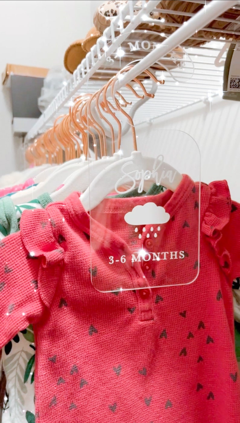May include: A clear acrylic hanger tag with the name "Sophia" written in cursive, a cloud with raindrops, and the text "3-6 MONTHS".