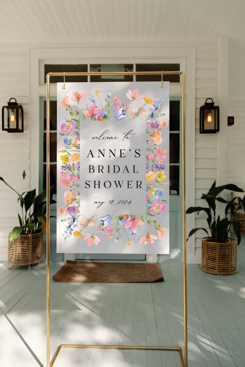 May include: A floral welcome sign for a bridal shower with the text "Welcome to Anne's Bridal Shower May 18, 2024".