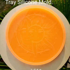 May include: An 8.5 inch orange silicone mold shaped like a tray with a sun and moon design. The mold is on a white surface. The text "JuliArt" is visible in the image.